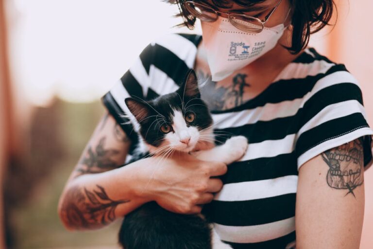 A Woman Carrying an Adorable Cat