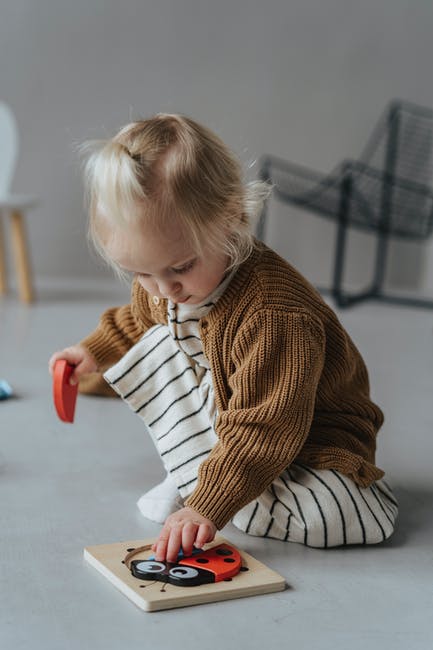 Girl in Brown Knitted Sweater Sitting on the Floor