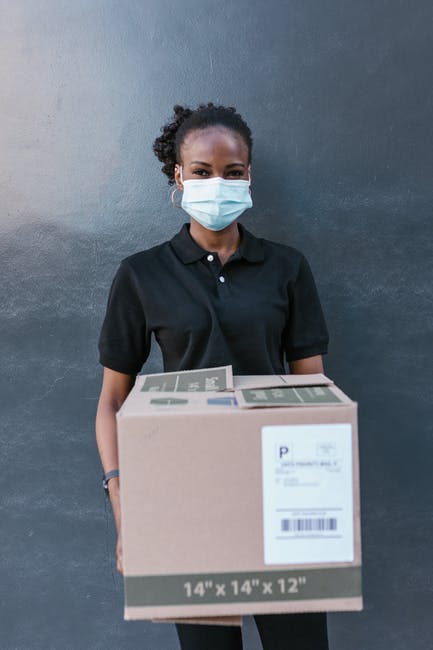 Woman in Black Polo Shirt Wearing White Face Mask