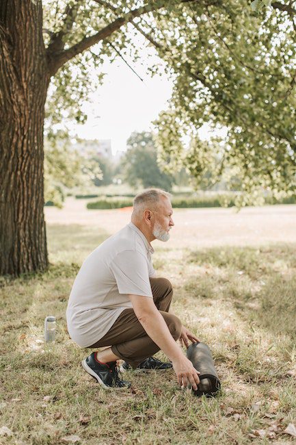 A Side View of an Elderly Man Preparing for Yoga