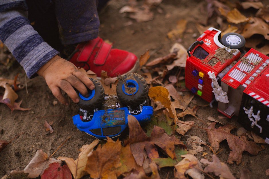 Crop kid playing with toy car