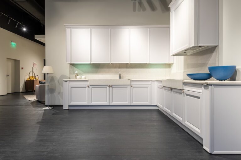 Modern white kitchen units in spacious showroom