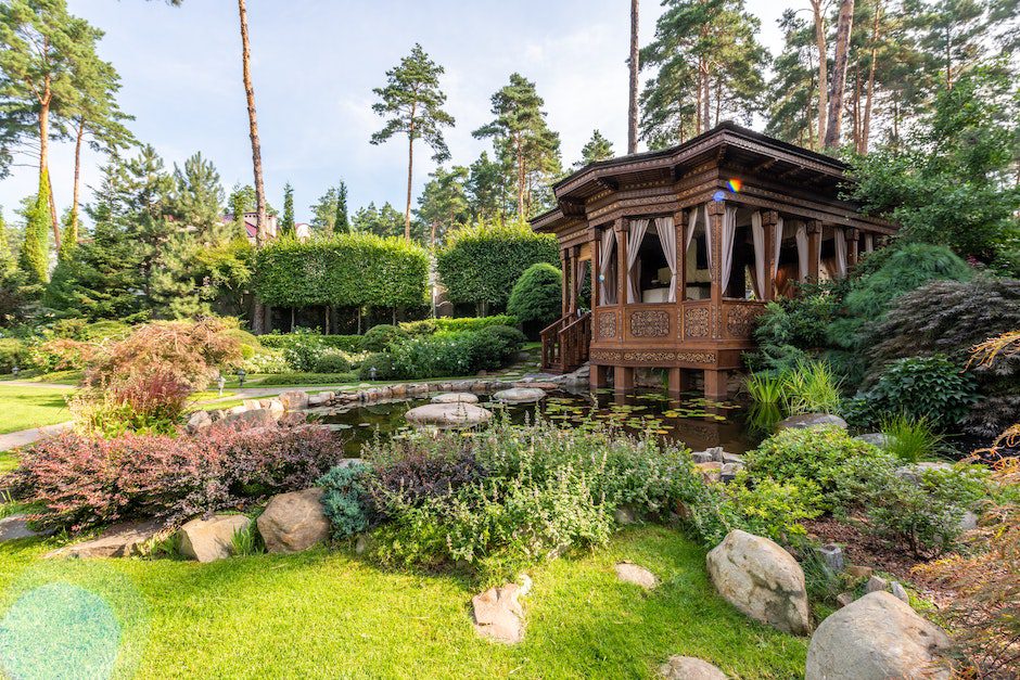 Gazebo near lake with rocks near plants