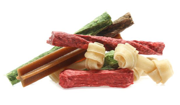 bones and colorful sticks for dog treat with vitamin and oral health on white background